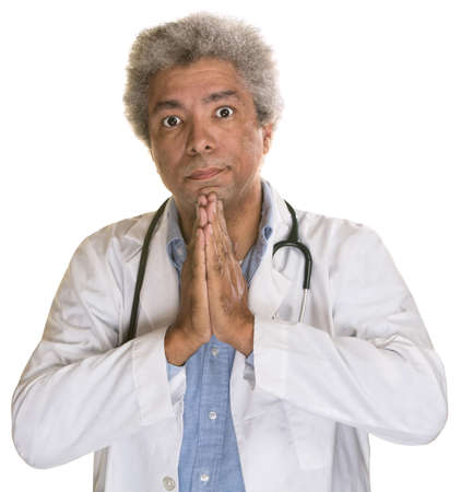 Wide eyed medical doctor with palms togetherの写真素材
