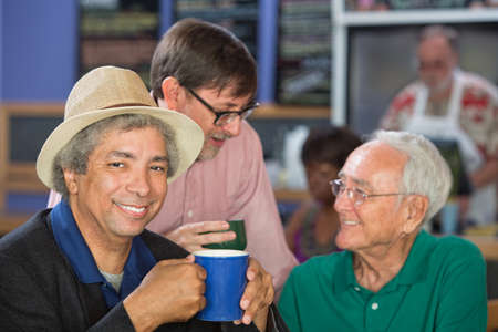 Diverse trio of adult men in bistroの写真素材