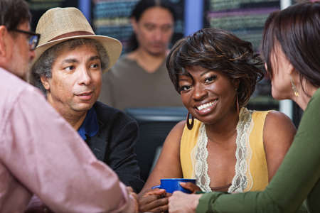 Cheerful woman with group in coffee house
