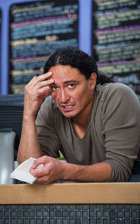 Stressed out Native American restaurant owner at counterの写真素材