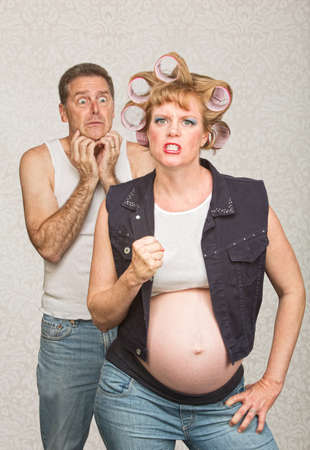 Intimidating pregnant hillbilly woman with scared husbandの写真素材