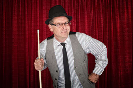 Sneering man in pinstripe shirt and poolstickの写真素材