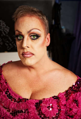 Serious drag queen without wig in dressing roomの写真素材