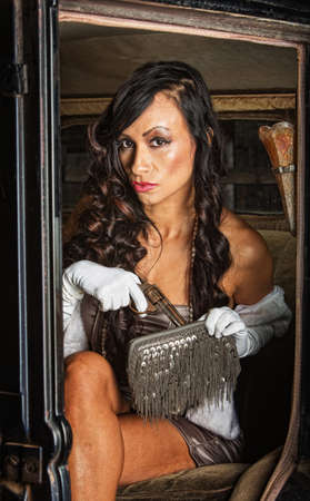 Sultry 1920s woman with pistol in small purse