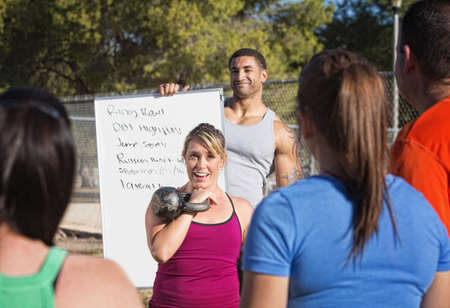 Fitness instructors explaining a list of exercises