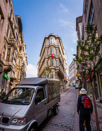 ISTANBUL, TURKEY â APRIL 27: Building with flag and tourist walking on April 27, 2012 in Istanbul, Turkey.  Each year patriotic Turks honor those fallen at the battle of Galipoli during World War I.のeditorial素材
