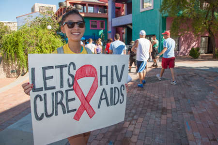 TUCSON, AZ/USA - OCTOBER 12:  Unidentified young woman encouraging AIDSwalk participants on October 12, 2014 in Tucson, Arizona, USA.のeditorial素材
