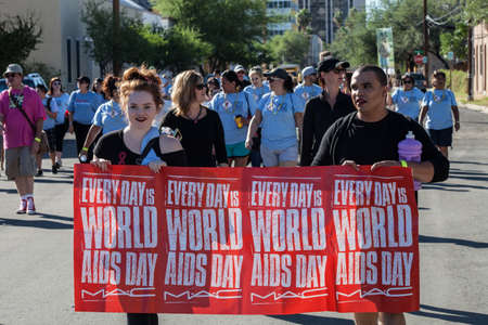 TUCSON, AZ/USA - OCTOBER 12:  Walker s with World AIDS Day sign at AIDSwalk on October 12, 2014 in Tucson, Arizona, USA.のeditorial素材