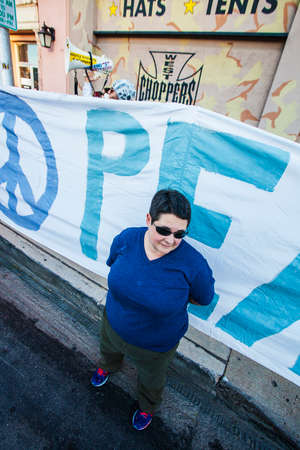 TUCSON, AZ/USA - NOVEMBER 09: Unidentified woman sheilds crowd from street preacher Brother Dean Saxton, at the All Souls Procession on November 09, 2014 in Tucson, AZ, USA.のeditorial素材