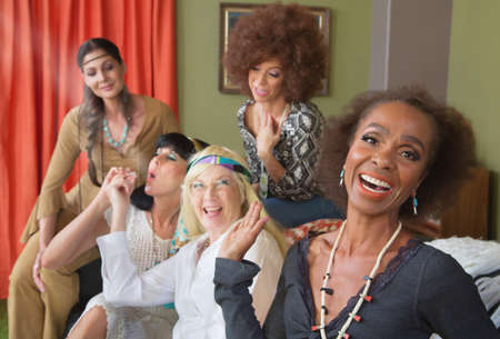 Woman laughing a middle aged group smoking potの写真素材