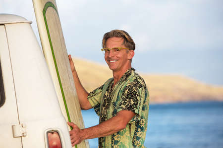 Happy single adult with his surfboard in Hawaiiの写真素材
