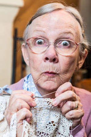 Elder woman with crochet and funny facial expressionの写真素材