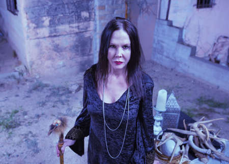 Scary priestess with fetish standing near altarの写真素材