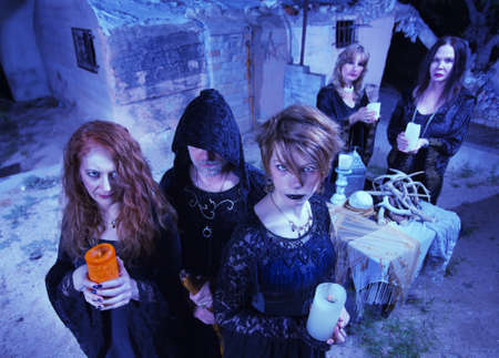 Coven of five witches outdoors holding candlesの写真素材