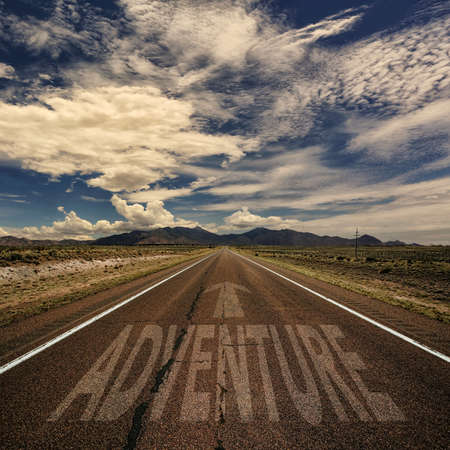 Desert road with the word adventure and arrowの写真素材