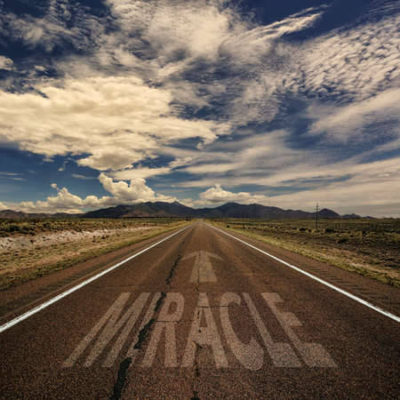 Conceptual image of desert road with the word miracle and arrowの写真素材