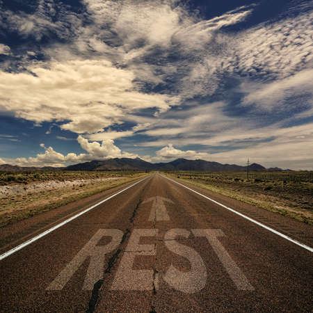 Conceptual image of desert road with the word rest and arrowの写真素材
