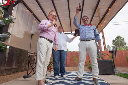 Minister with male gay couple celebrating their marriageの写真素材