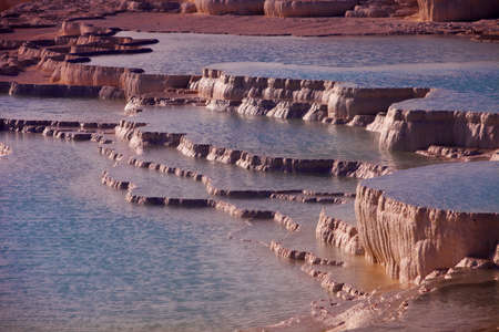 Terraces formed by mineral rich hot springs water at Pamukkale in Turkeyの写真素材