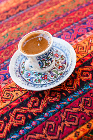Turkish style coffe in traditional small cup on colorful backgroundの写真素材