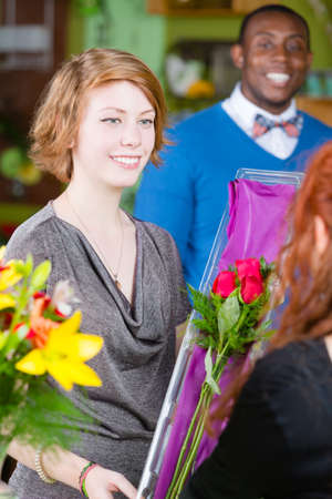 Teen girl purchasing roses at a florist shopの写真素材