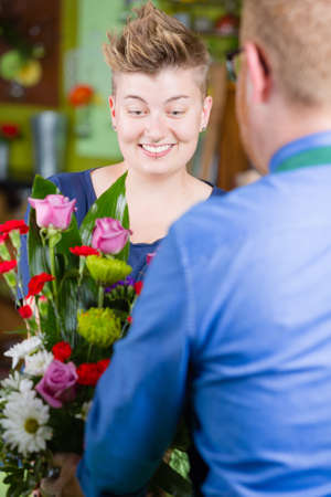 Pretty woman buying arrangement at a florist shopの写真素材