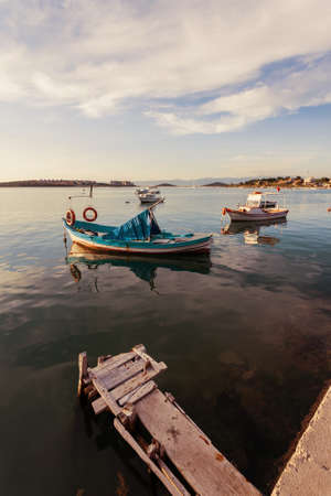 Boats moored in the Aegean sea at the town of Ayvalik in Turkey.の写真素材