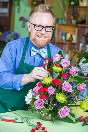 Single handsome man creating a flower arrangementの写真素材