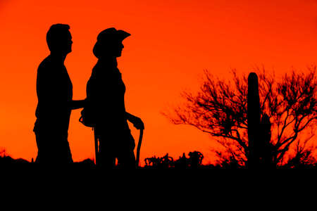 Two afternoon desert hikers in the American Southwest in silhouetteの写真素材