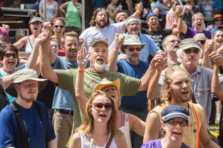 HOT SPRINGS, NC - JULY 10: Large group of worshipers holding hands at the Wild Goose Festival on...