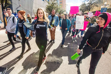 TUCSON, AZ - JANUARY 21: Adult and teenage women marching in street during Women's March on Washington protest rally. January 21, 2017 in Tucson, AZ, USA.のeditorial素材