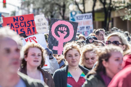 TUCSON, AZ - JANUARY 21: Selective focus view of woman holding pink female with fist sign at the Women's March on Washington January 21, 2017 in Tucson, AZ, USA.のeditorial素材