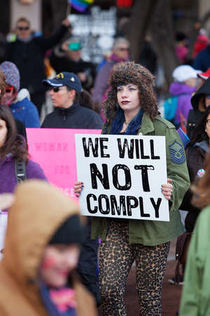 TUCSON, AZ - JANUARY 21: Tall woman holding sign of defiance at the Women's March on Washington protest January 21, 2017 in Tucson, AZ, USA.のeditorial素材