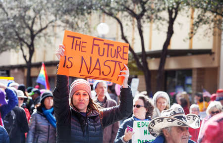 TUCSON, AZ - JANUARY 21: Adult female in hat holding The Future Is Nasty protest poster during the Women's March on Washington January 21, 2017 in Tucson, AZ, USA.のeditorial素材