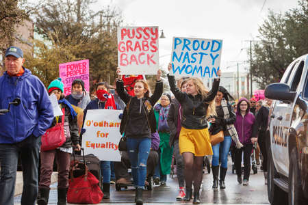 TUCSON, AZ - JANUARY 21: Two teen girls holding protest signs about female empowerment for Women's March on Washington January 21, 2017 in Tucson, AZ, USA.のeditorial素材