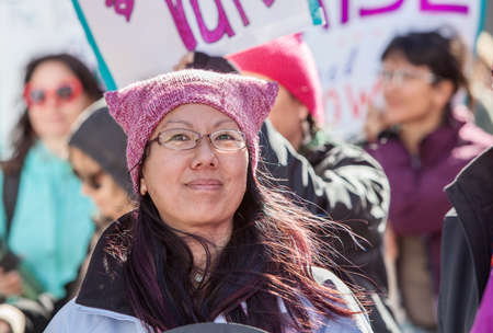 TUCSON, AZ - JANUARY 21: Grinning woman in eyeglasses with pink pussy hat celebrating the Women's March on Washington January 21, 2017 in Tucson, AZ, USA.のeditorial素材