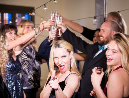 Smiling mature woman at a party or reception being sillyの写真素材
