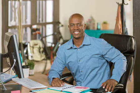 Handsome professional man working in a creative officeの写真素材