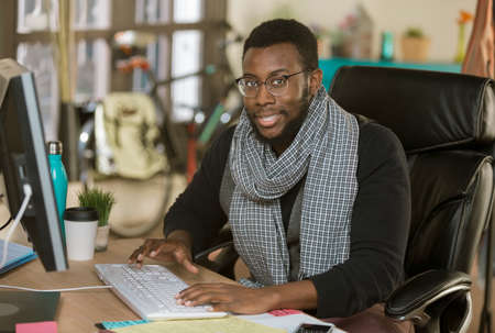 Handsome professional man working in a creative officeの写真素材