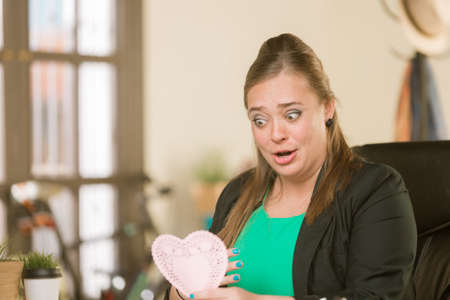 Young creative professional woman reacting to Valentine messageの写真素材