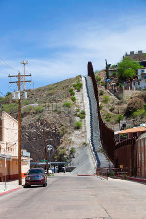 United States border wall with Nogales Mexico on the right and surveillance tower on the leftの写真素材