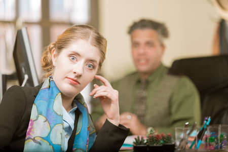 Young professional woman reacting to clueless male colleague