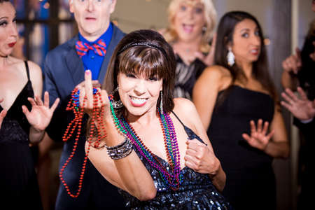 Obnoxious woman with beads makes a rude gestureの写真素材