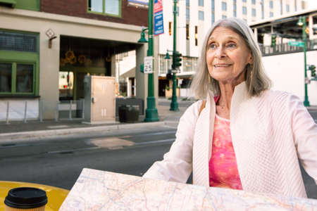Woman in a city center with a road mapの写真素材