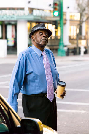 Handsome senior man downtown looking upの写真素材