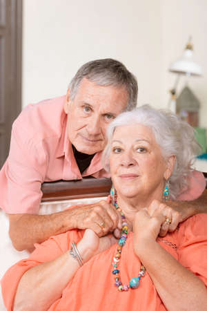 Cheerful senior man and woman at home with neutral expressionsの写真素材