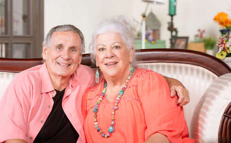 Senior man and woman at home smilingの写真素材