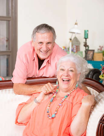 Affectionate senior man and woman at homeの写真素材