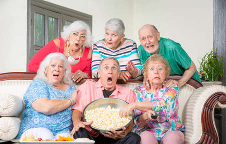 Six shocked senior friends reacting to televisionの写真素材