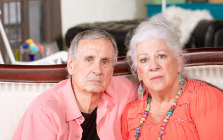 Unhappy or upset senior man and woman at homeの写真素材